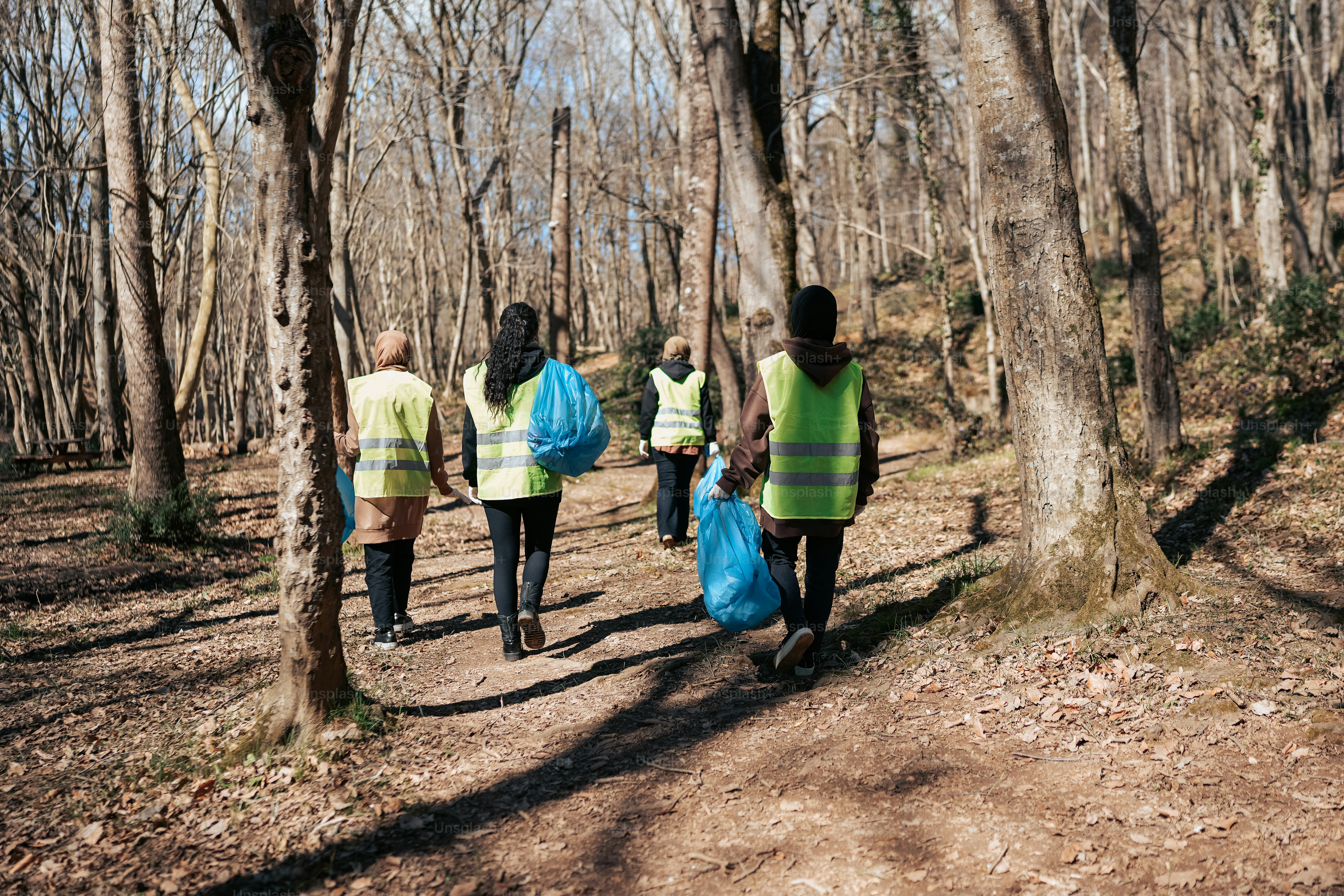 A group of people walking through a forest photo Helping people Image