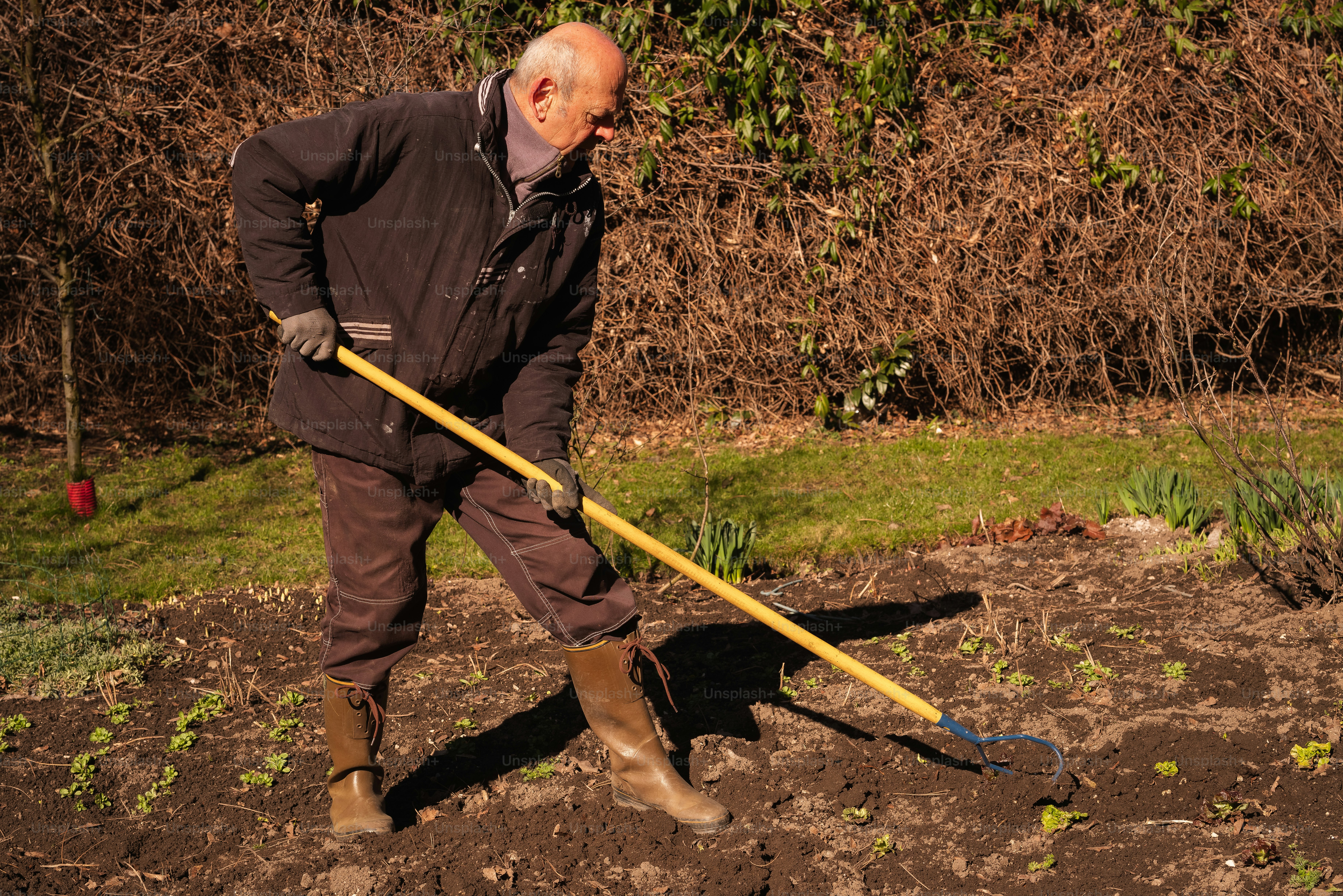 A man is digging in the dirt with a shovel photo Landscape garden Image on Unsplash
