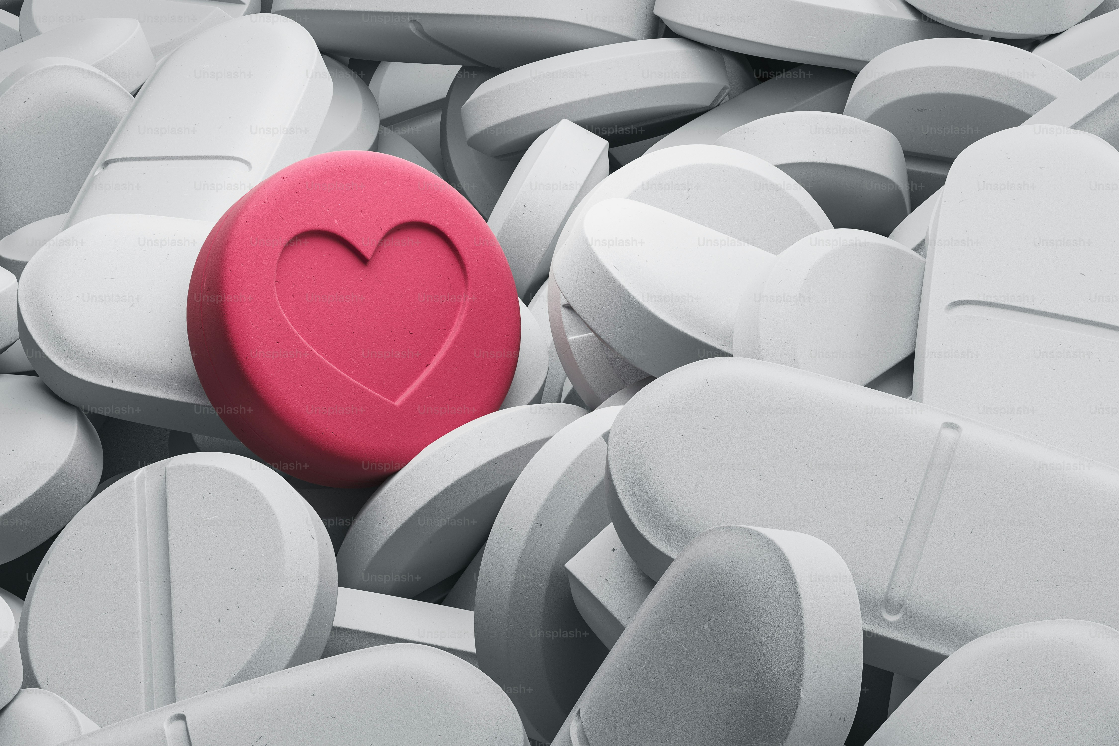 One red pill with heart sign among many white pills the concept of