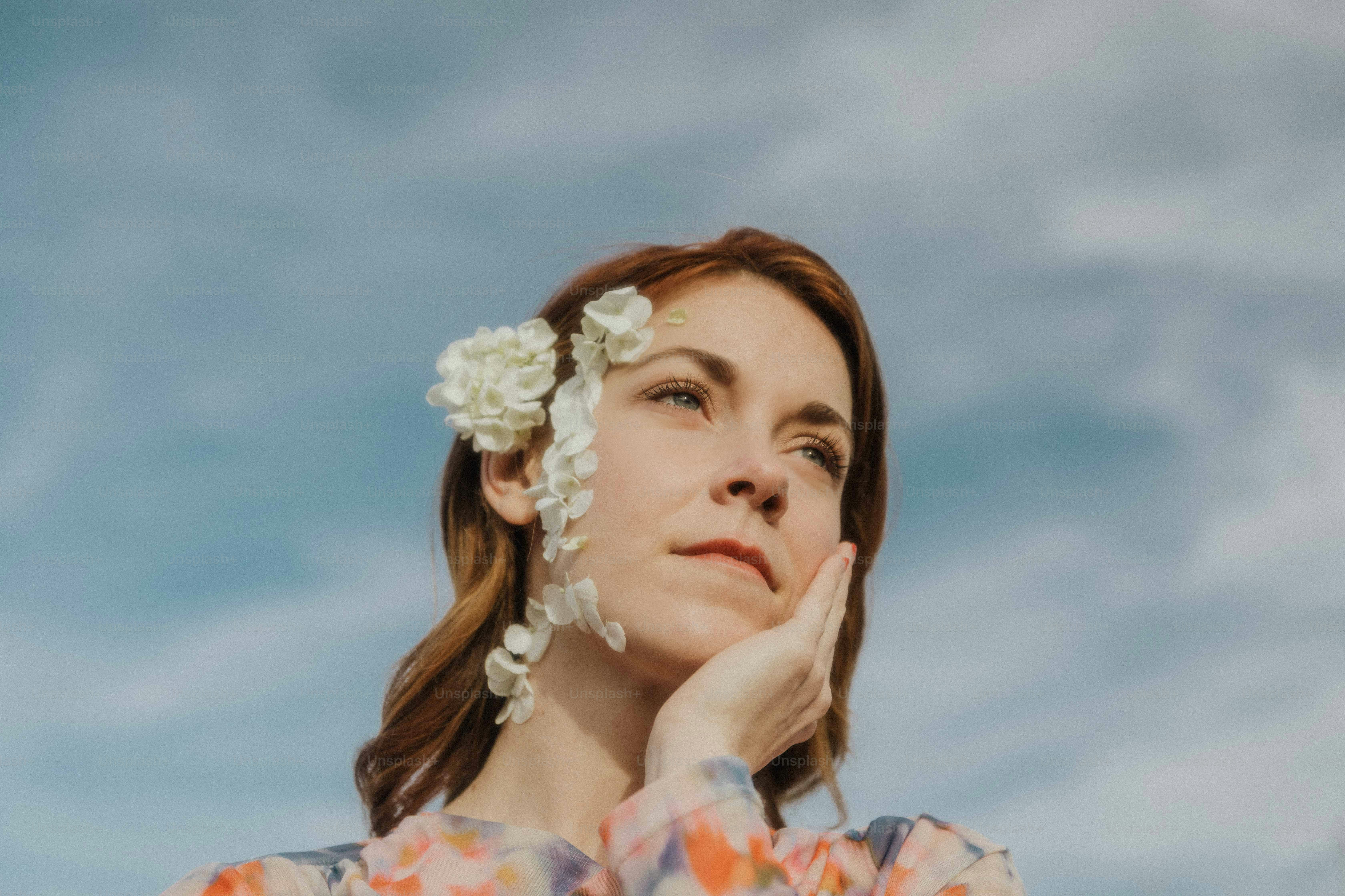 A woman laying down with flowers in her hair photo Woman Image on