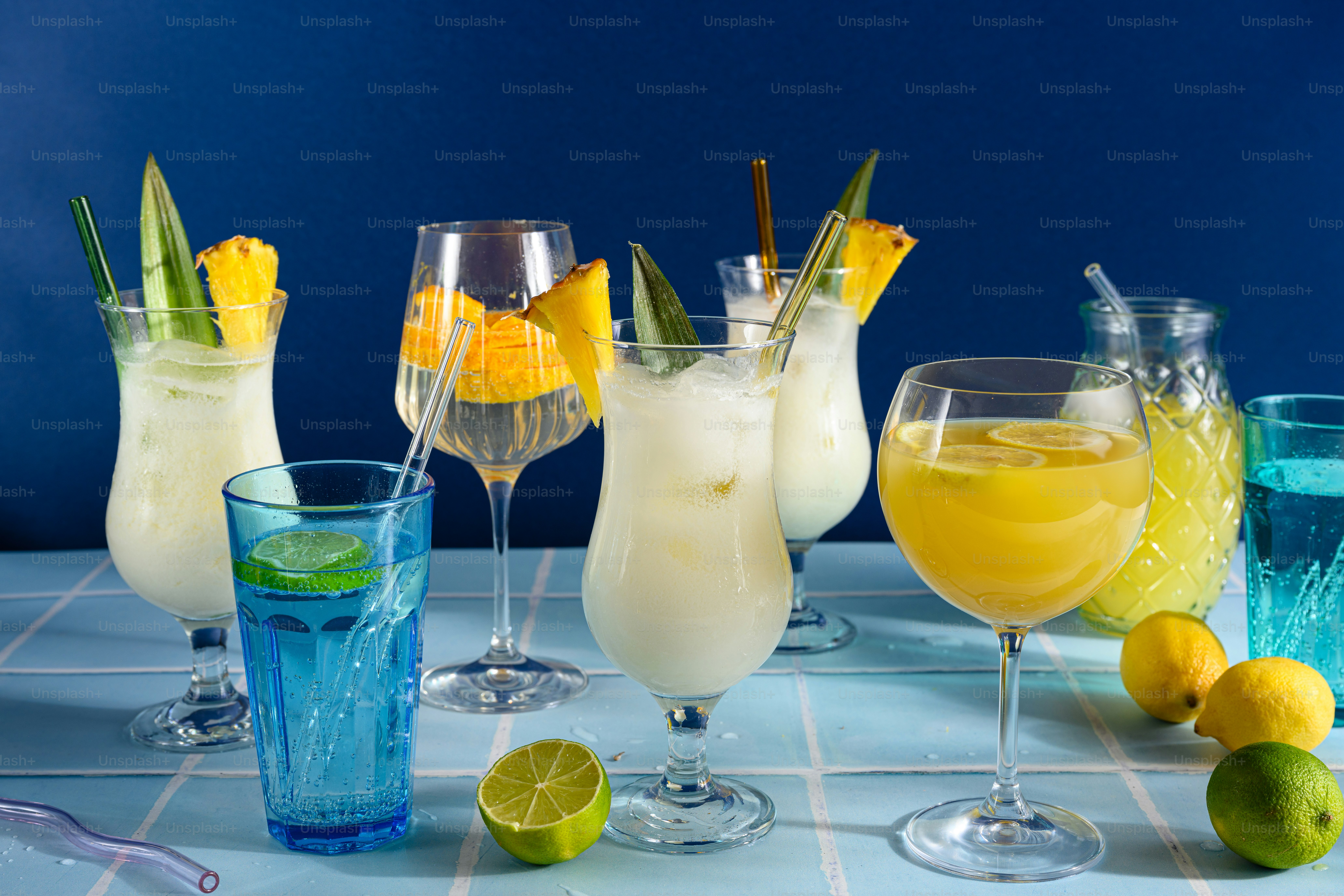 A table topped with glasses filled with different types of drinks photo