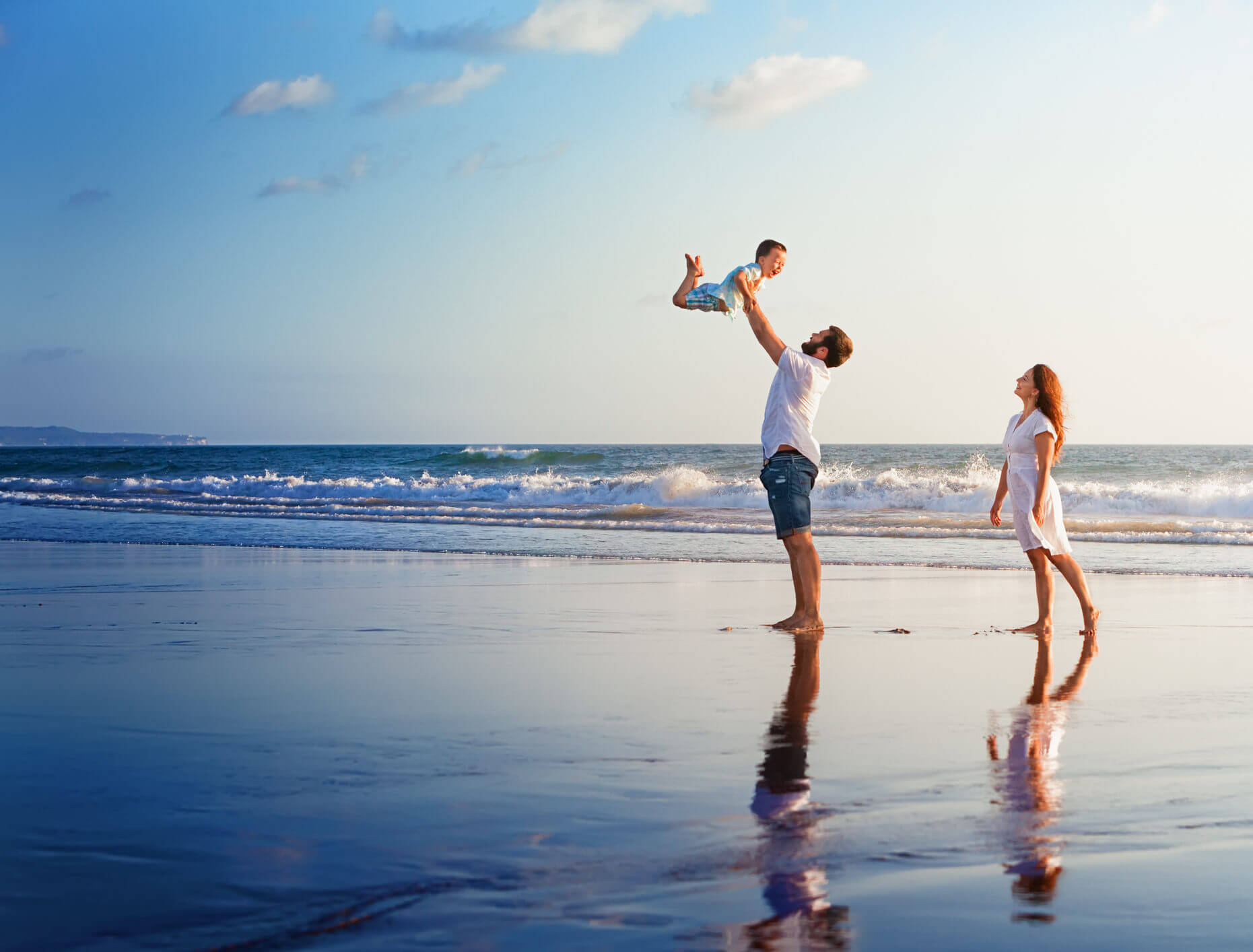Happy family walking with fun on sunset sea beach Property Management