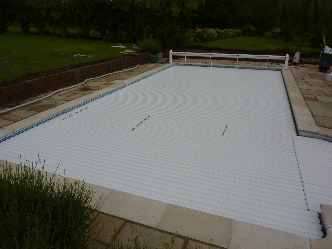 Swimming pool safety covers, slatted pool covers