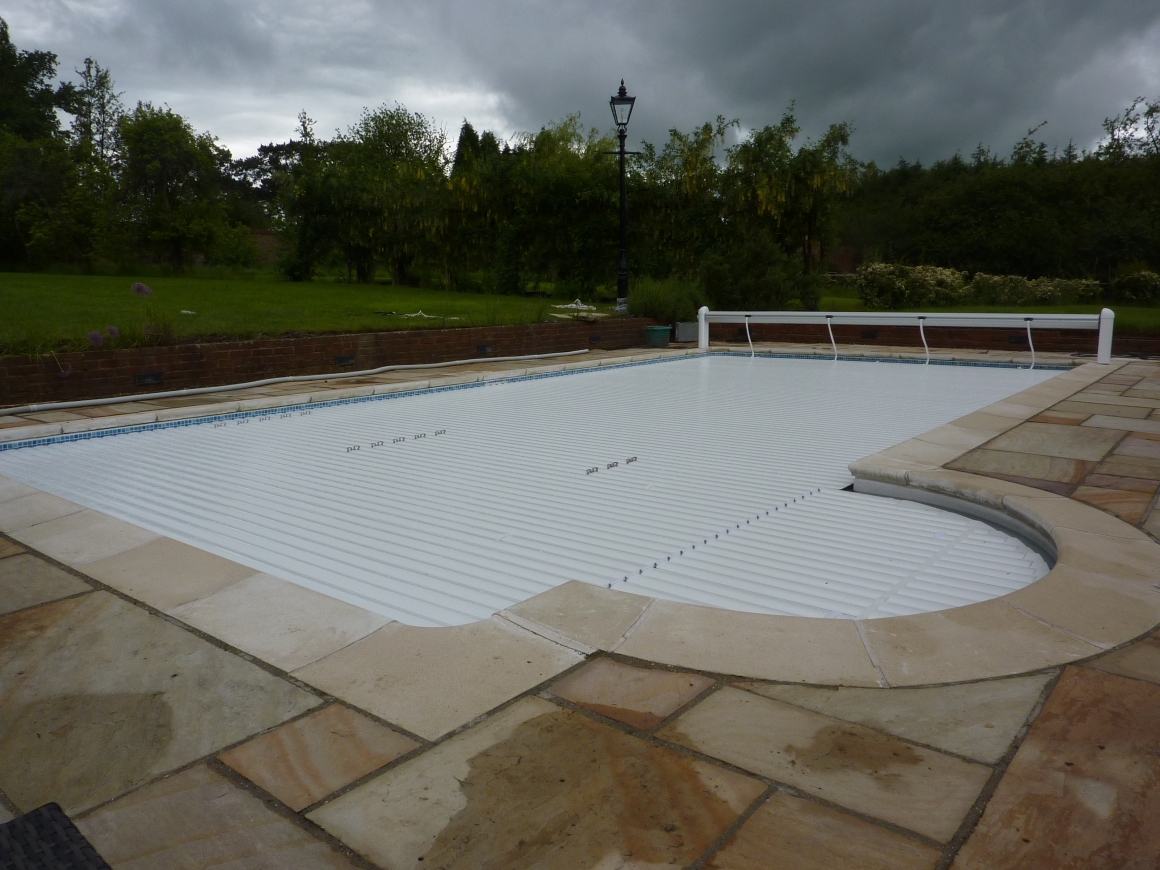 Swimming pool safety covers, slatted pool covers