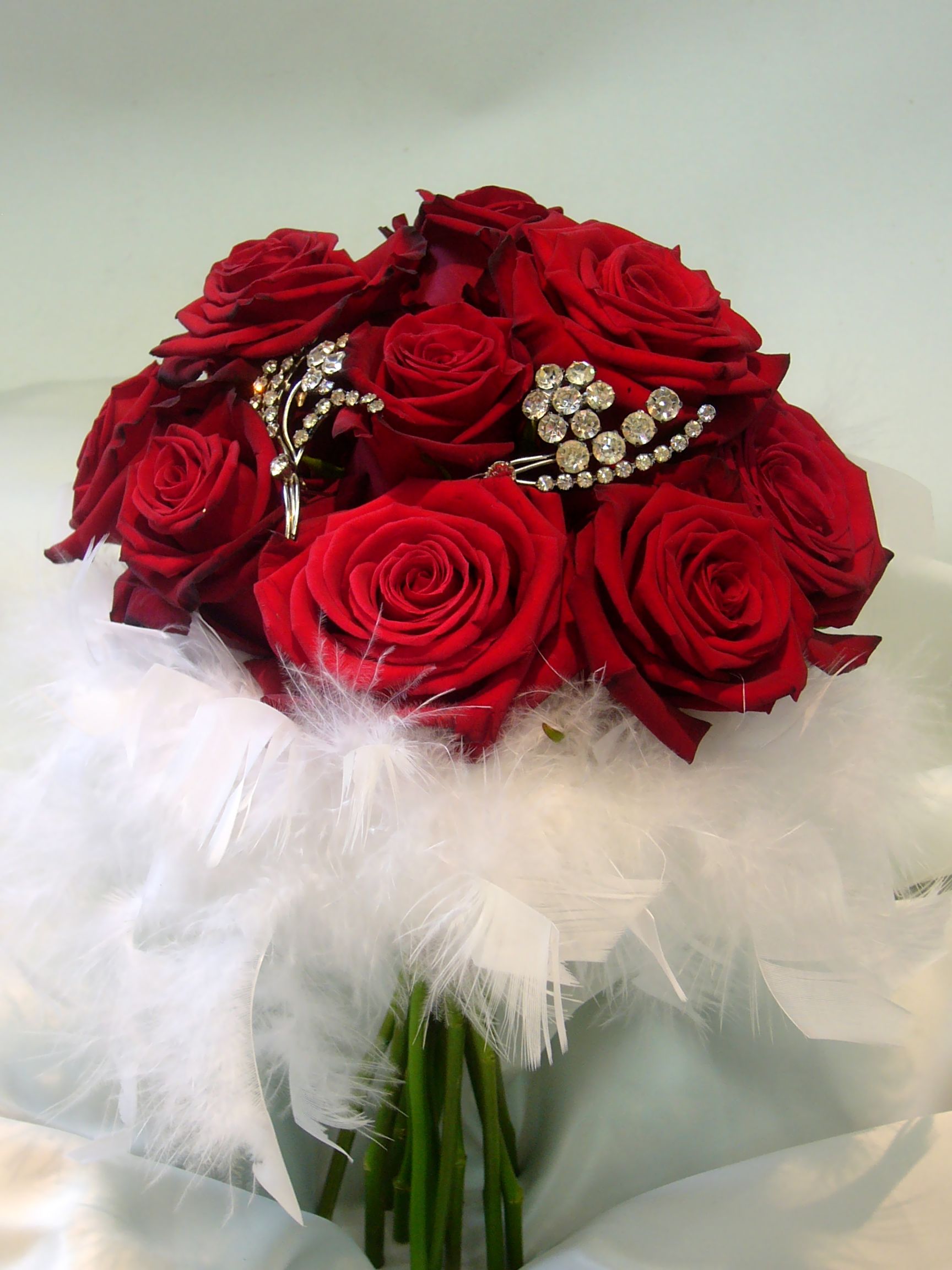 Red rose brooch bouquet with feathers Wedding Pinterest