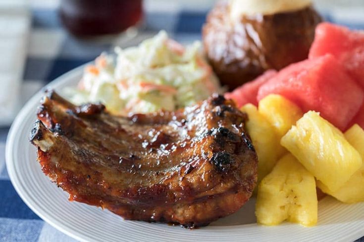 Pressure Cooker BBQ Baby Back Ribs served on a plate with coleslaw, pineapple chunks and chunks of watermelon