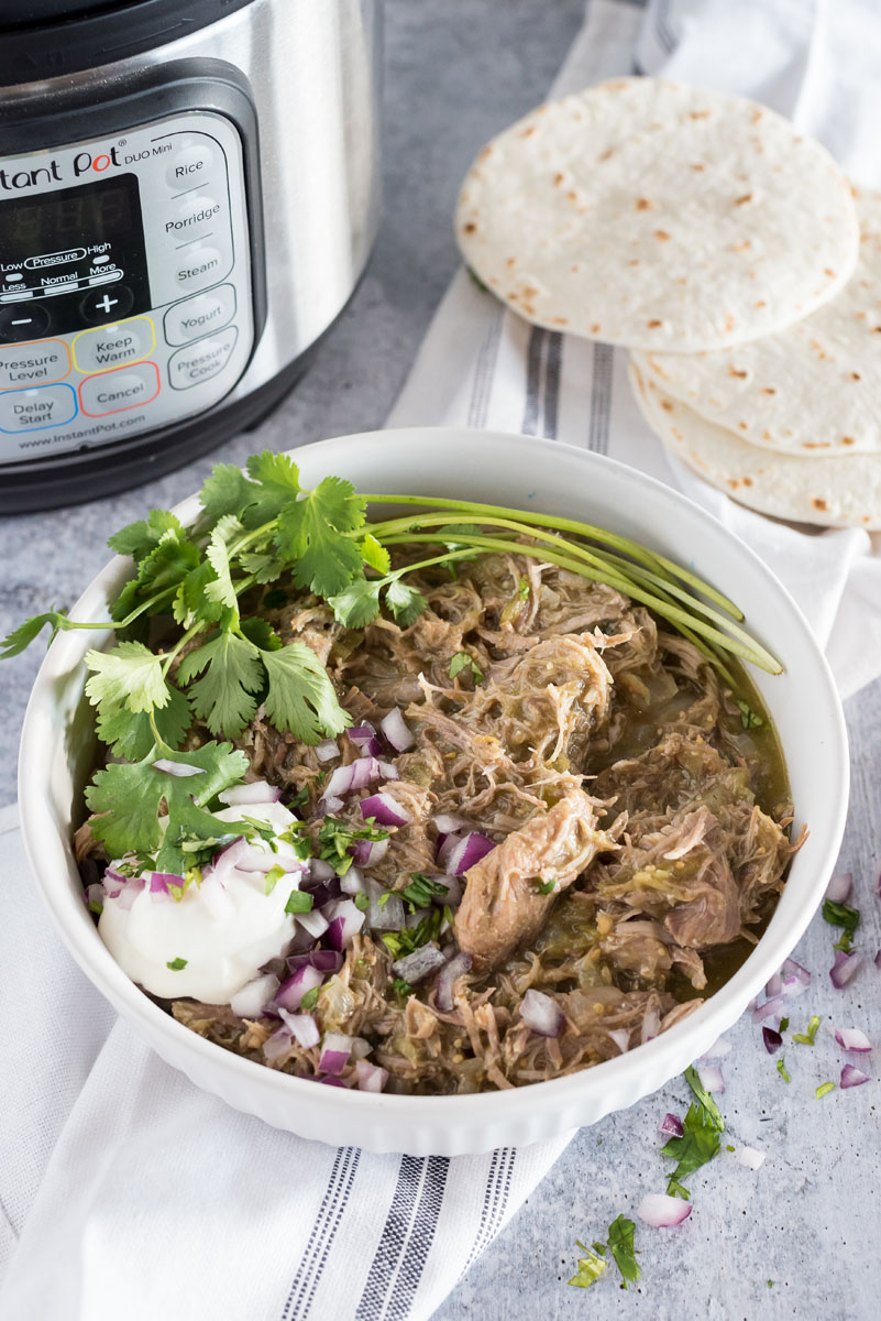 bowl of instant pot chili verde with fresh cilantro