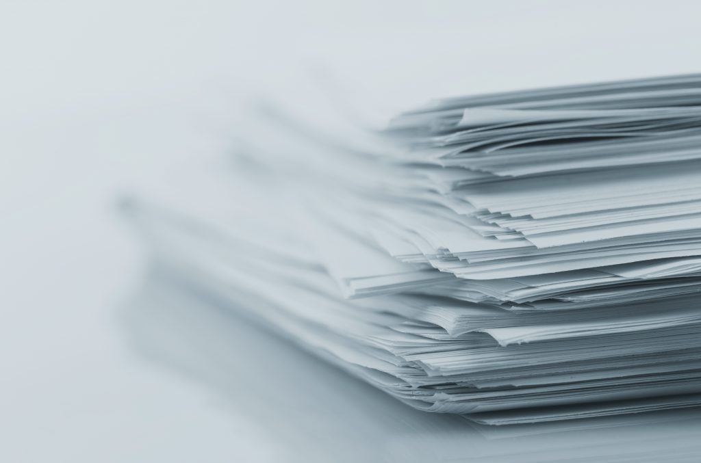 Stack of white papers ProcureAbility