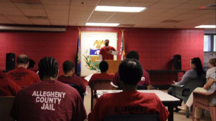 Chris Westbrooks Jr., also known as Brother Umar, reads from one of his poems in the Allegheny County Jail: "It's about color no more. Only two races exist, the rich and the poor." (Photo by Molly Duerig / PublicSource)