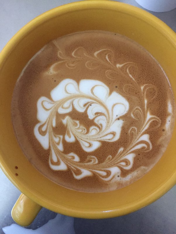 How do baristas make those perfect swirly designs in the foam of a