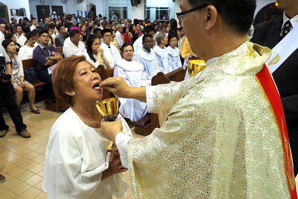 Can a priest who drinks a glass of wine during mass (blood of Christ