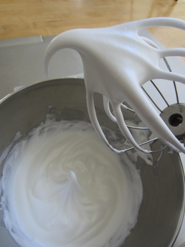 What are some tips for whipping egg whites to soft peaks or stiff peaks