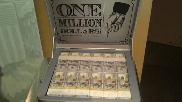 What size of a cube would 1,000,000 dollars in 100 dollar bills make