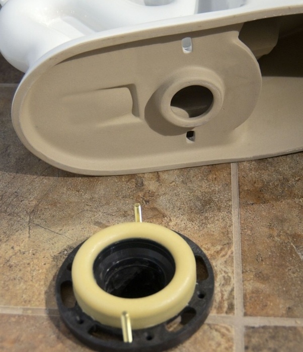 When flushing the toilet some water is leaking out of the bottom/ how