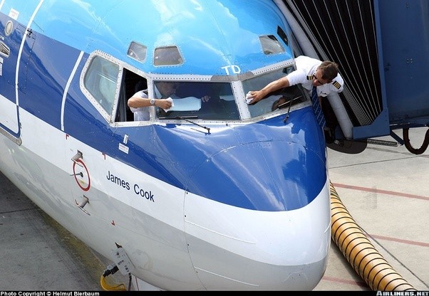 How does a pilot clean a window from the outside on a large aircraft
