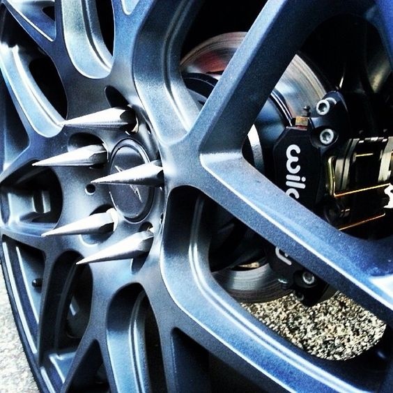 Why do many semi trucks have spikes on the side of their front tires