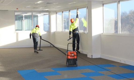 How do construction companies clean up the dust and debris after