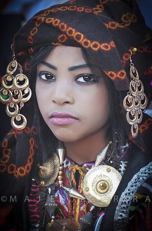 Why do some Arabs have African features? I mean the curly