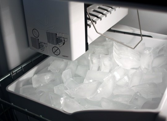 In a refrigerator that can dispense water from the freezer, where does