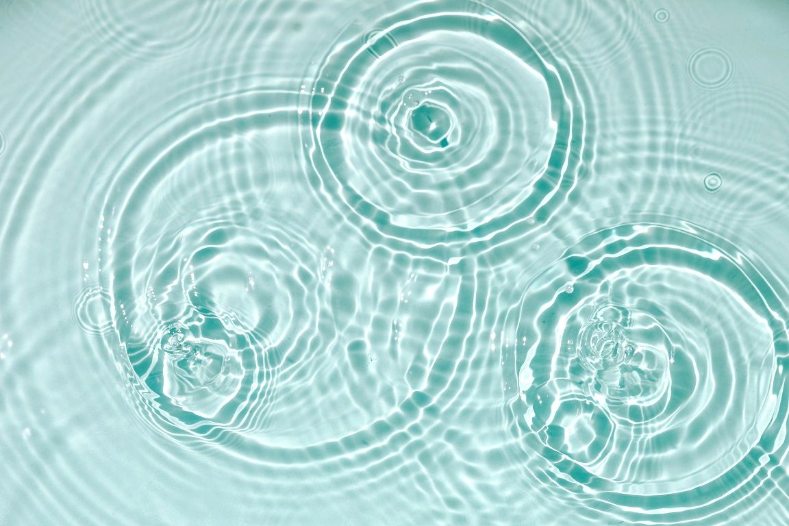Blue water texture, blue mint water surface with rings and ripples. Spa