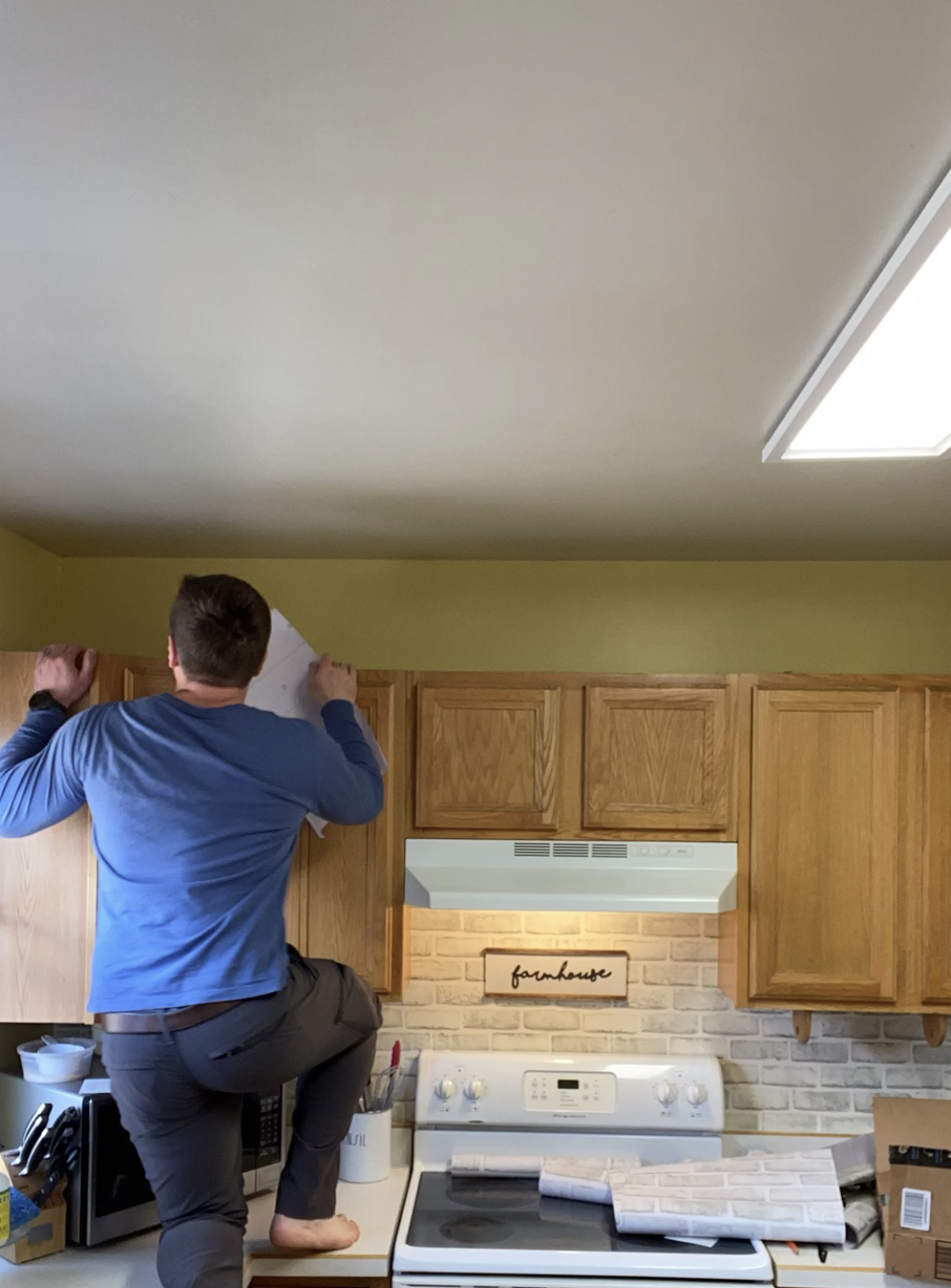 man putting on wallpaper