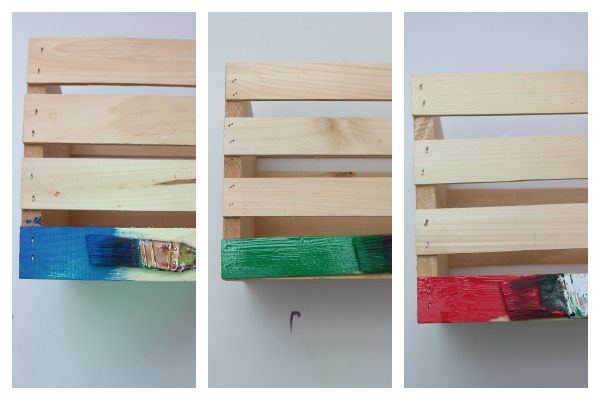 how to make a toy wagon out of crates - painting crates red, blue and green.