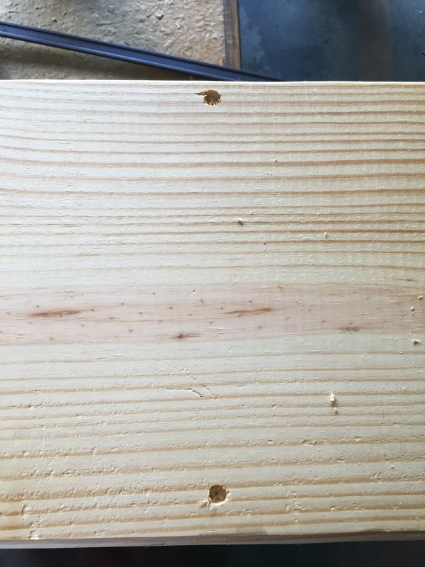 Drilling pilot holes in the shelves for the DIY rustic bookshelf - Rain on a Tin Roof