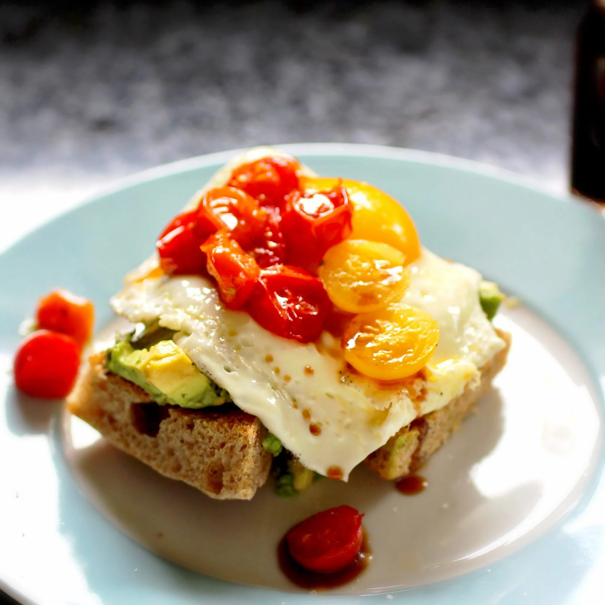 Avocado and Egg Elevated Avocado toast with broiled tomatoes and date