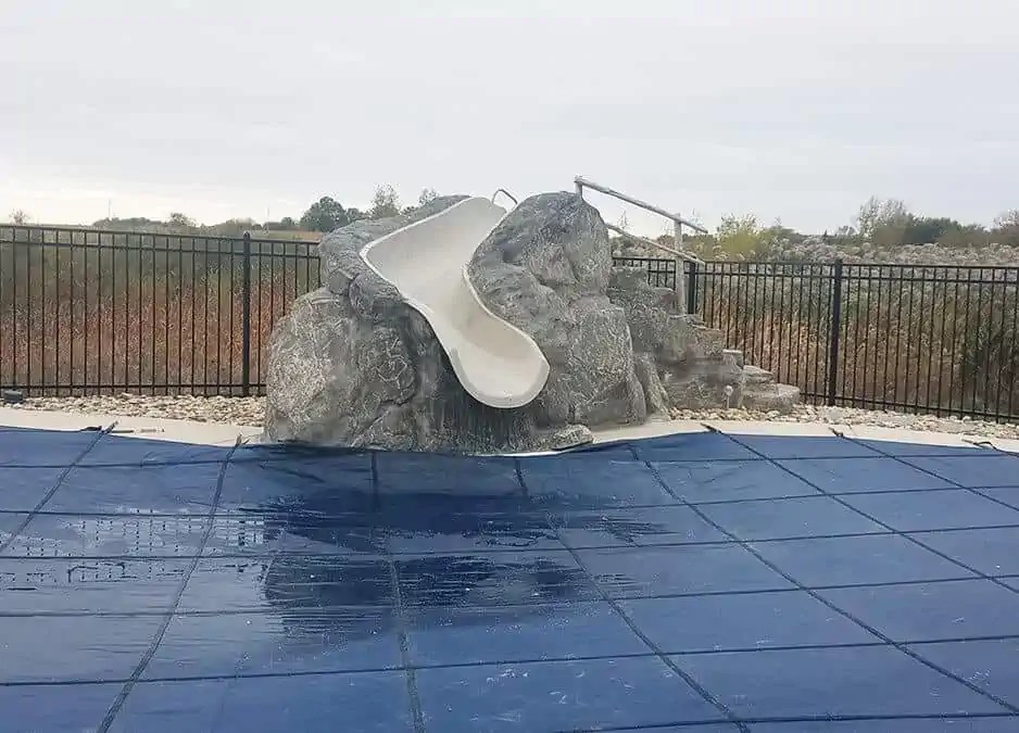 Fiberglass slide with RicoRock boulders and steps
