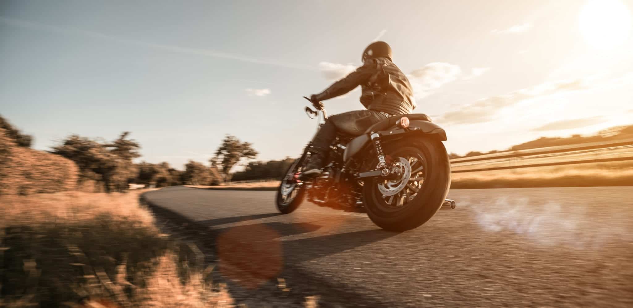Man riding sportster motorcycle during sunset. Romain Berg