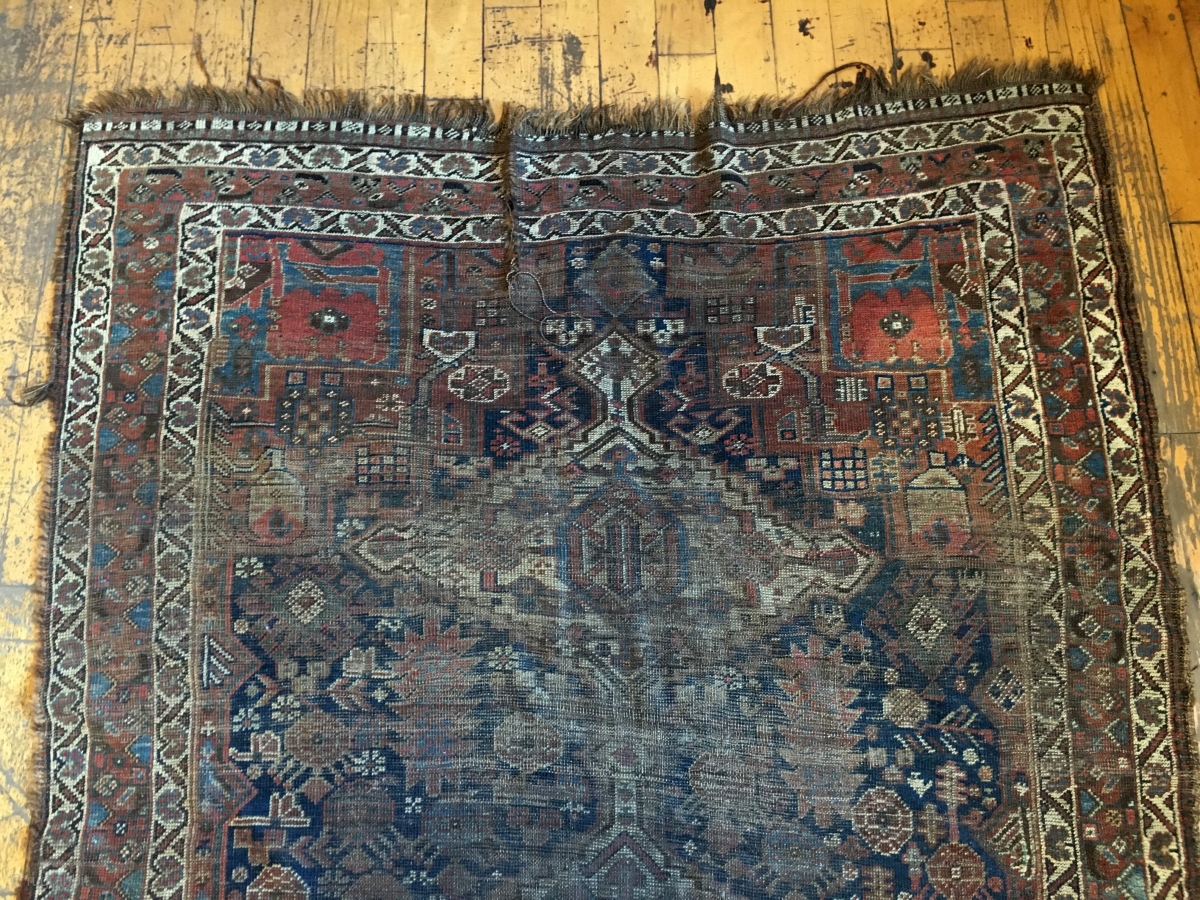 Back room storage clean out. Old South Persian rug. Dirty, worn