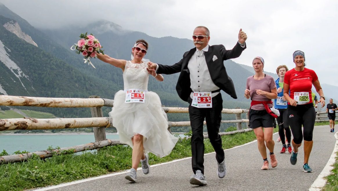 Wedding dress and running shoes runners tie the knot during race in