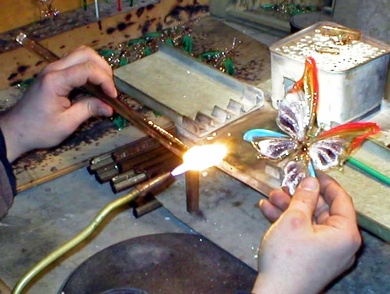 Glass working in technique of lampworking for making glass figurines