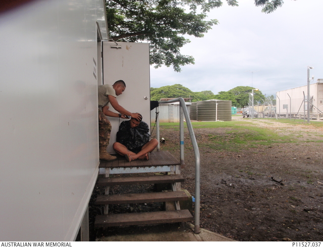 Weekly hair cut time for Royal Tongan Marines at their barracks at
