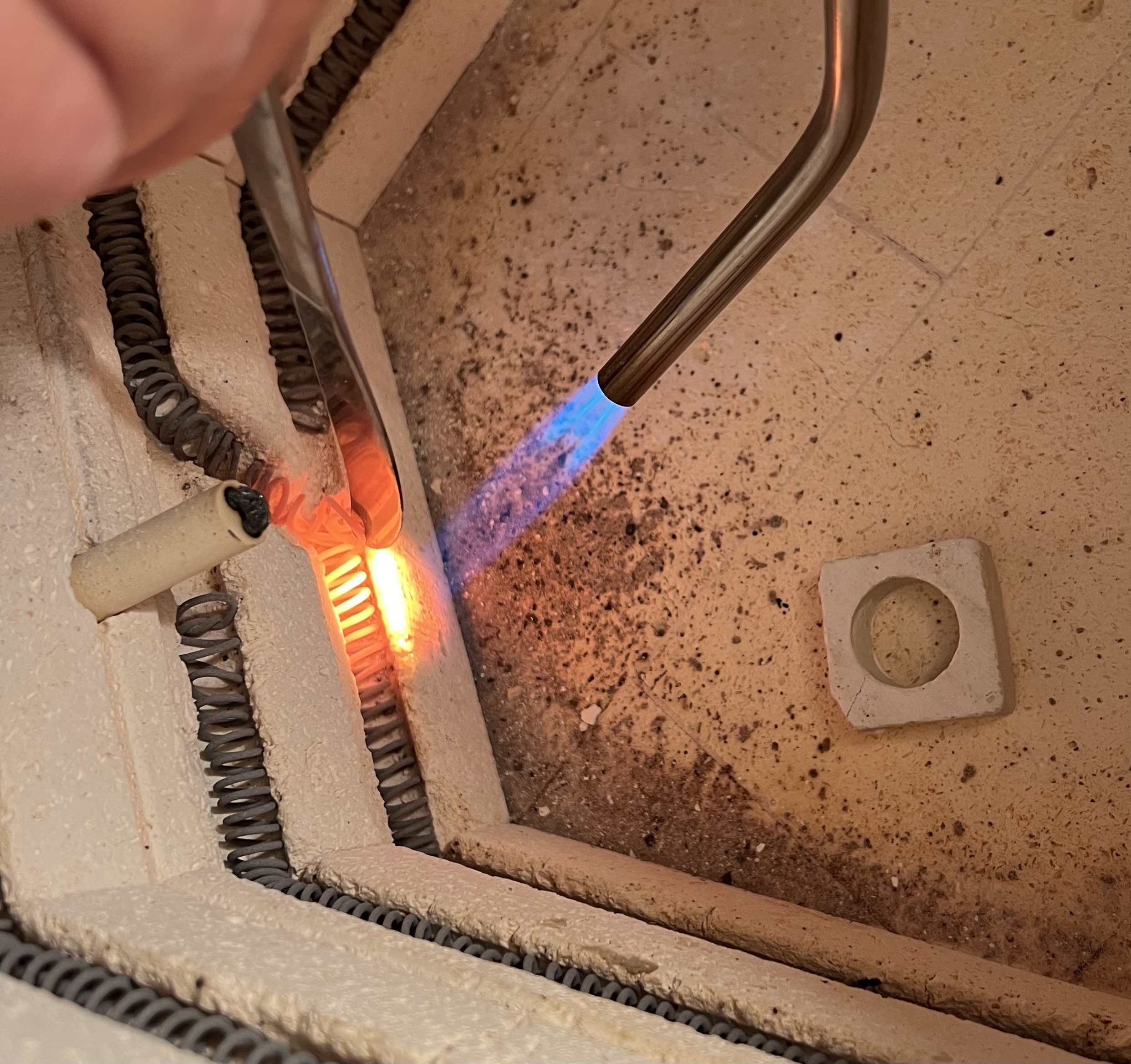 Pushing kiln elements back into the groove