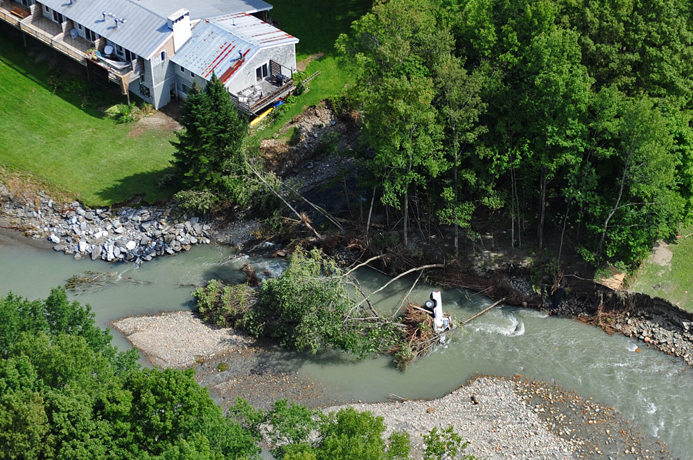 south on route 100 a full size truck is upside down in the river