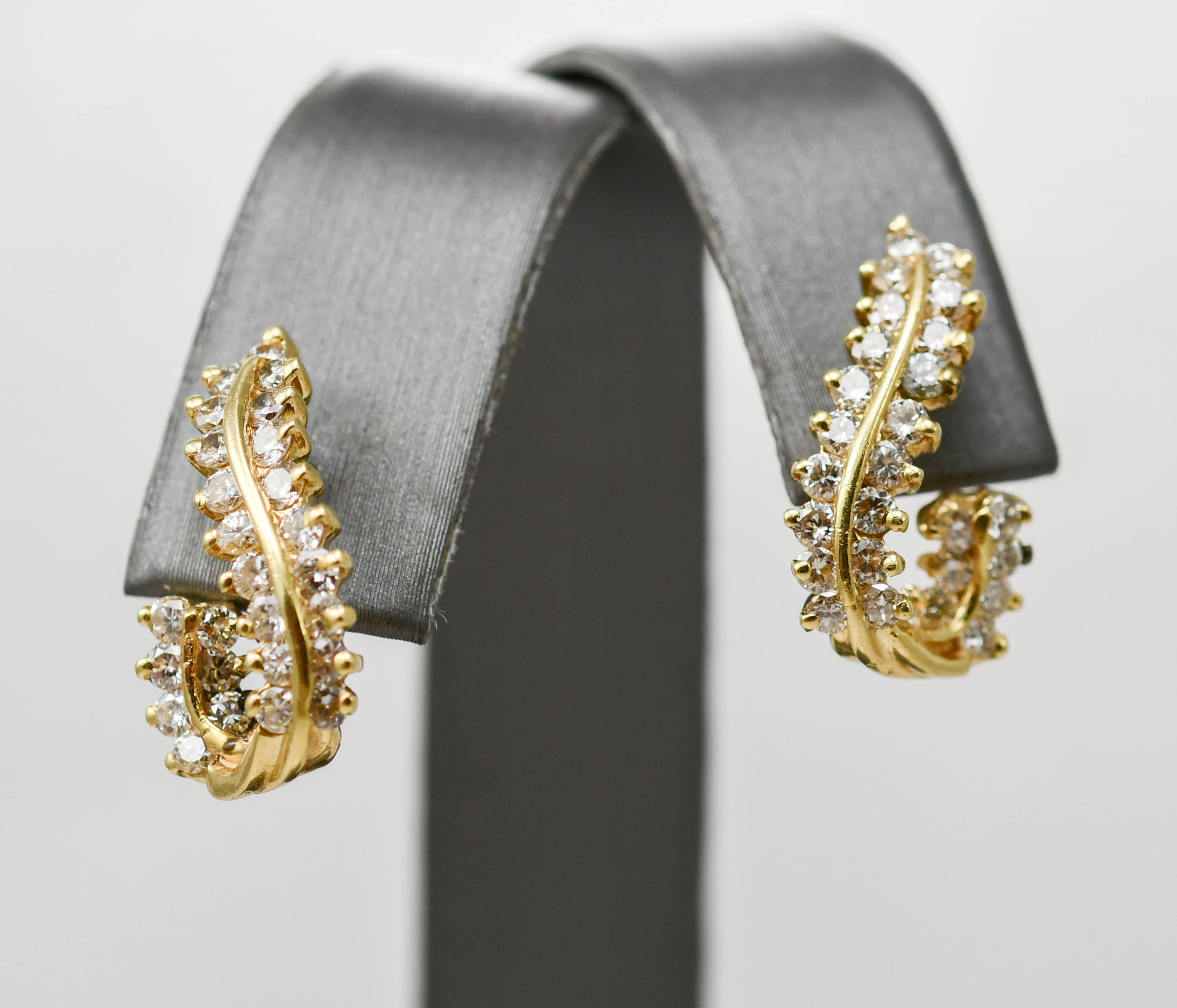 Ladies diamond JShaped earrings in 14k yellow gold. 1.25tdw Tangible