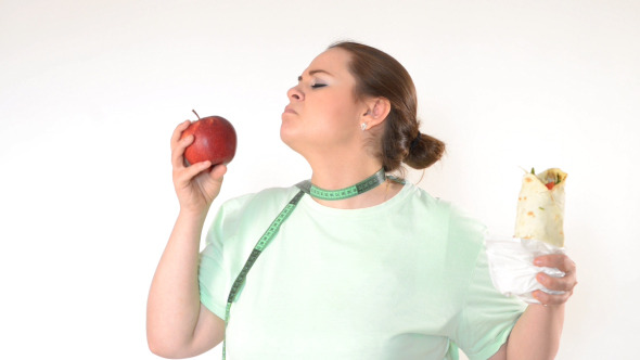 Corpulent Woman Struggling to Eat Healthy by oneblink1 VideoHive