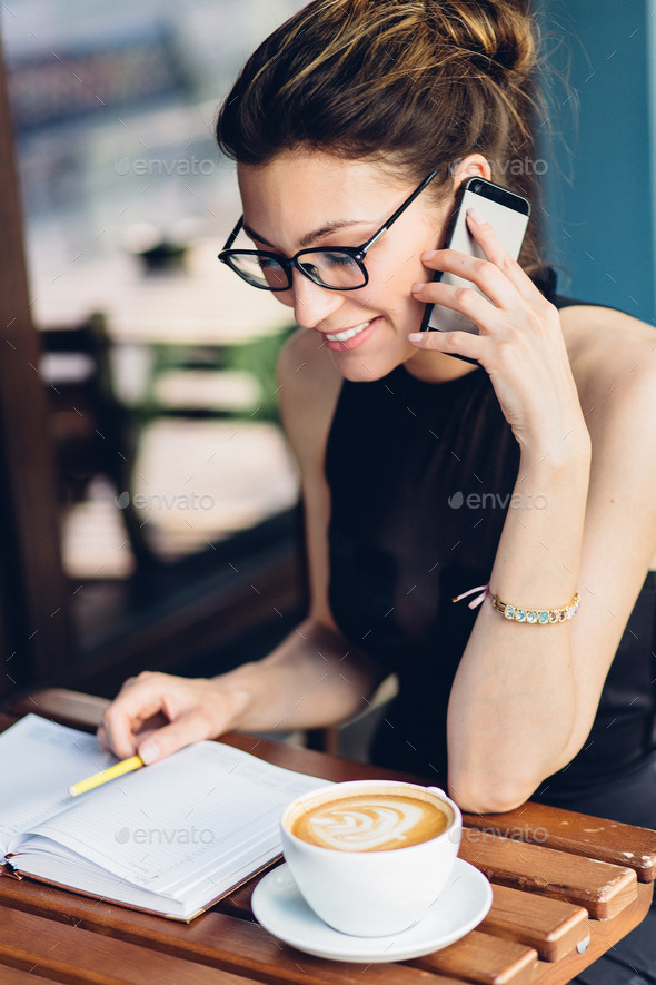 Attractive girl talking on the phone Stock Photo by