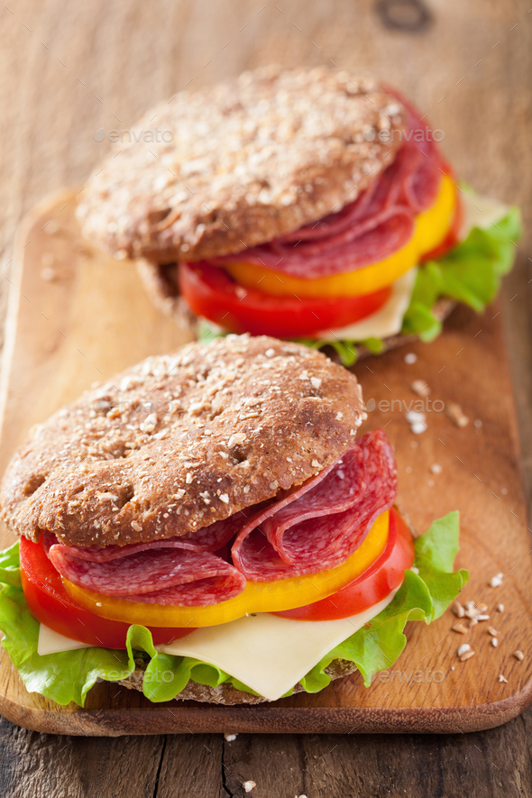 healthy salami sandwich with tomato pepper and lettuce Stock Photo by