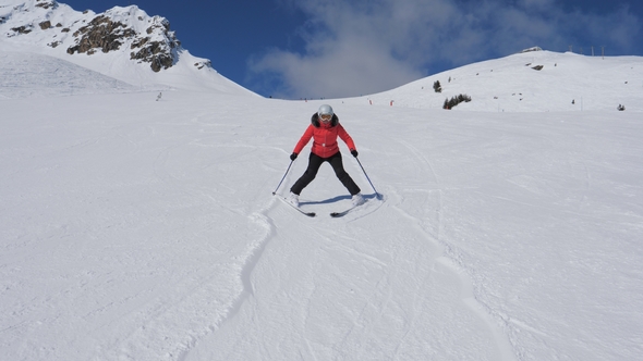 Beginner Skier Woman Carefully And Slowing Skiing Down On Ski Slope by