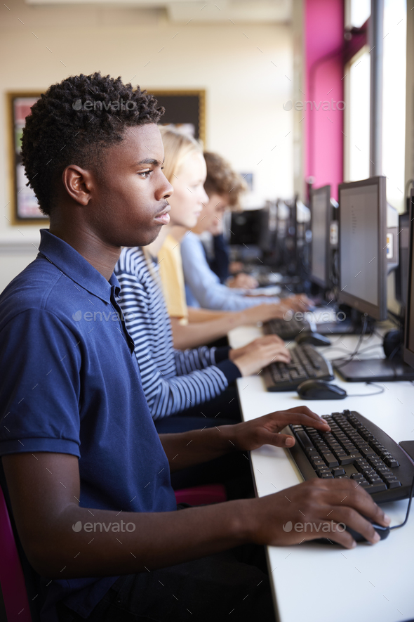Line Of Teenage High School Students Studying In Computer Class Stock