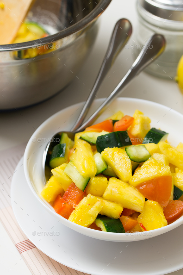 Fruit salad with pineapple, cucumber and tomato Stock Photo by kenishirotie