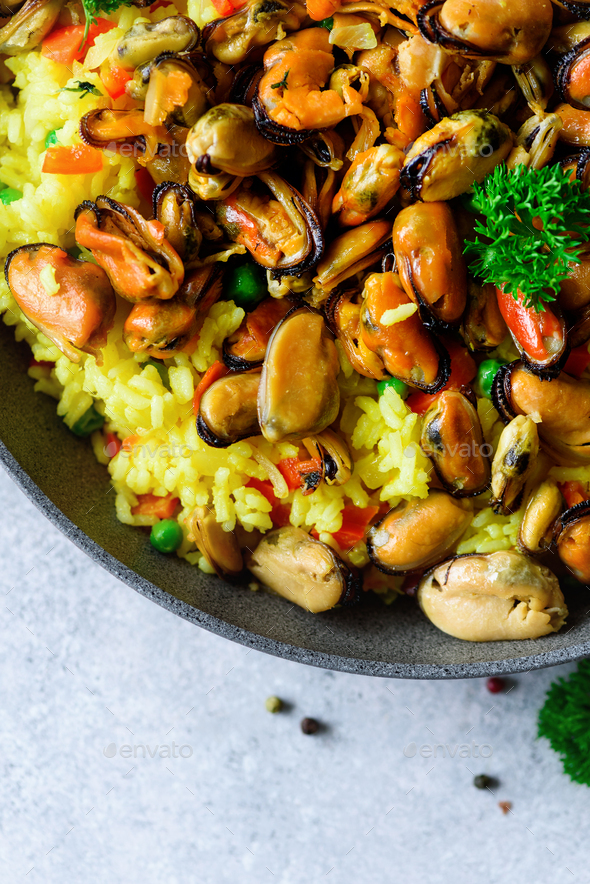 Traditional spanish seafood paella in pan rice, peas, shrimps, mussels
