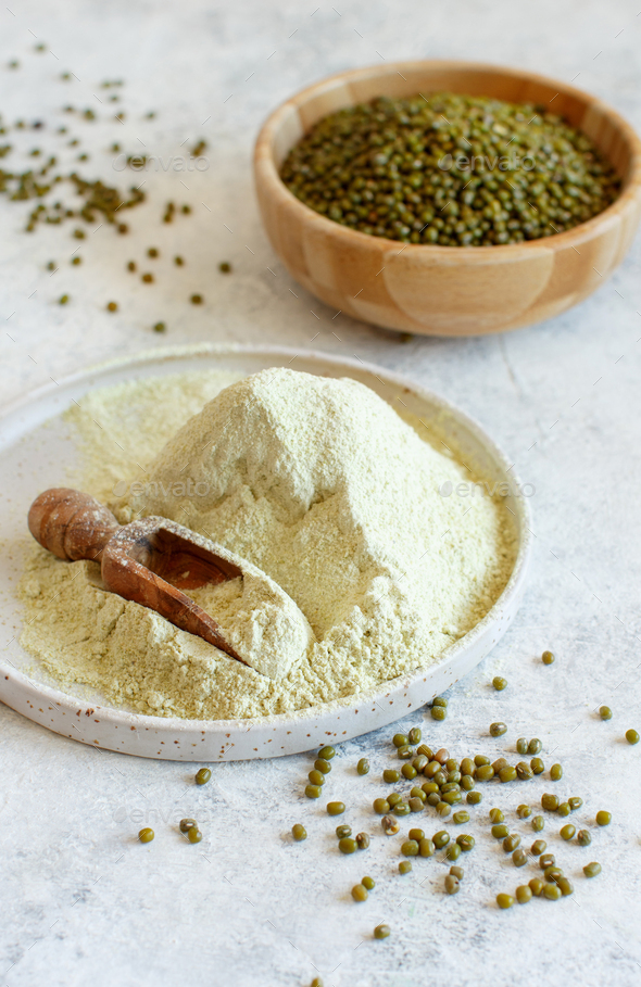 Mung beans flour and grain with a wooden spoon Stock Photo by katrinshine