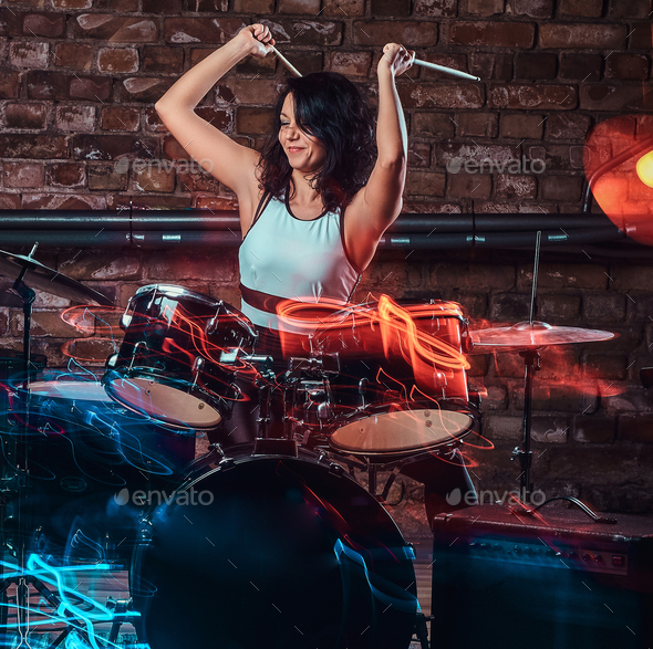 Young girl musician playing on drums and cymbals. Live music in a night club Stock Photo by fxquadro
