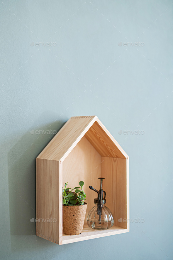 Wooden house shelf with decorations on the wall, natural decor concept