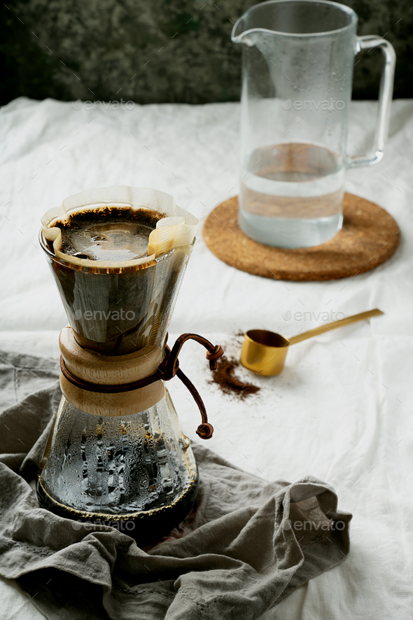Preparing filtered coffee with dripper Stock Photo by SebastianaRaw
