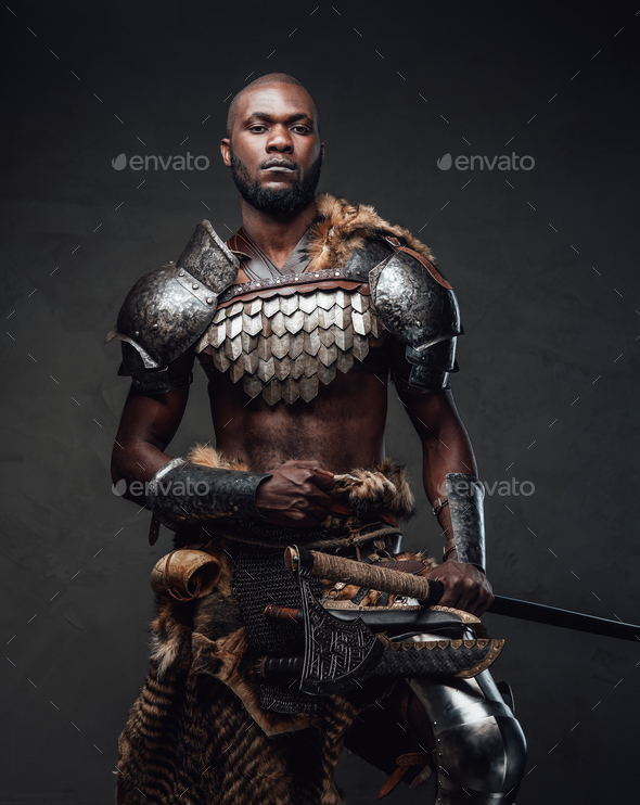 Powerful and handsome authentic soldier wearing armor with axe Stock
