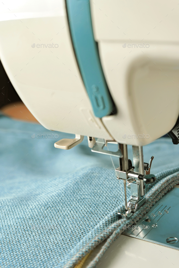 Modern sewing machine with special pressure foot. Process of sewing